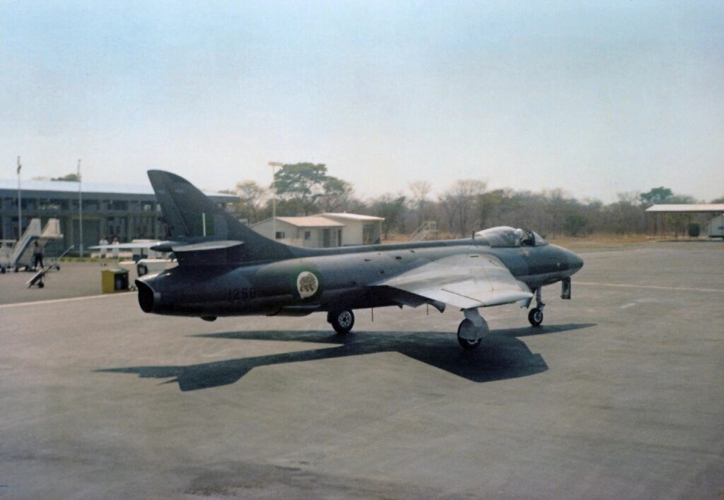 The Hawker Hunter and Rhodesia’s Bush War 4 Sqn Ldr Rob Gaunt taxies Hunter FGA9 R1258, wearing the attractive new green-and-white roundels, past the terminal building at Victoria Falls while on stand-by to attack an incursion across the Zambezi