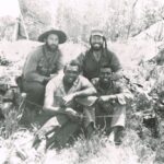Front, from left – ‘Idi’ AMIN, right – unknown. Back, from left – Derek, and right, SGT-MAJ Ben BOTHA. The patrol consisted of five men (the fifth man, CPL CHISOLM, was holding the camera) who had walked from the base to the drop-off point ready for OP (Observation Post) work. The men were observing a village known to have supplied the enemy with food and water.